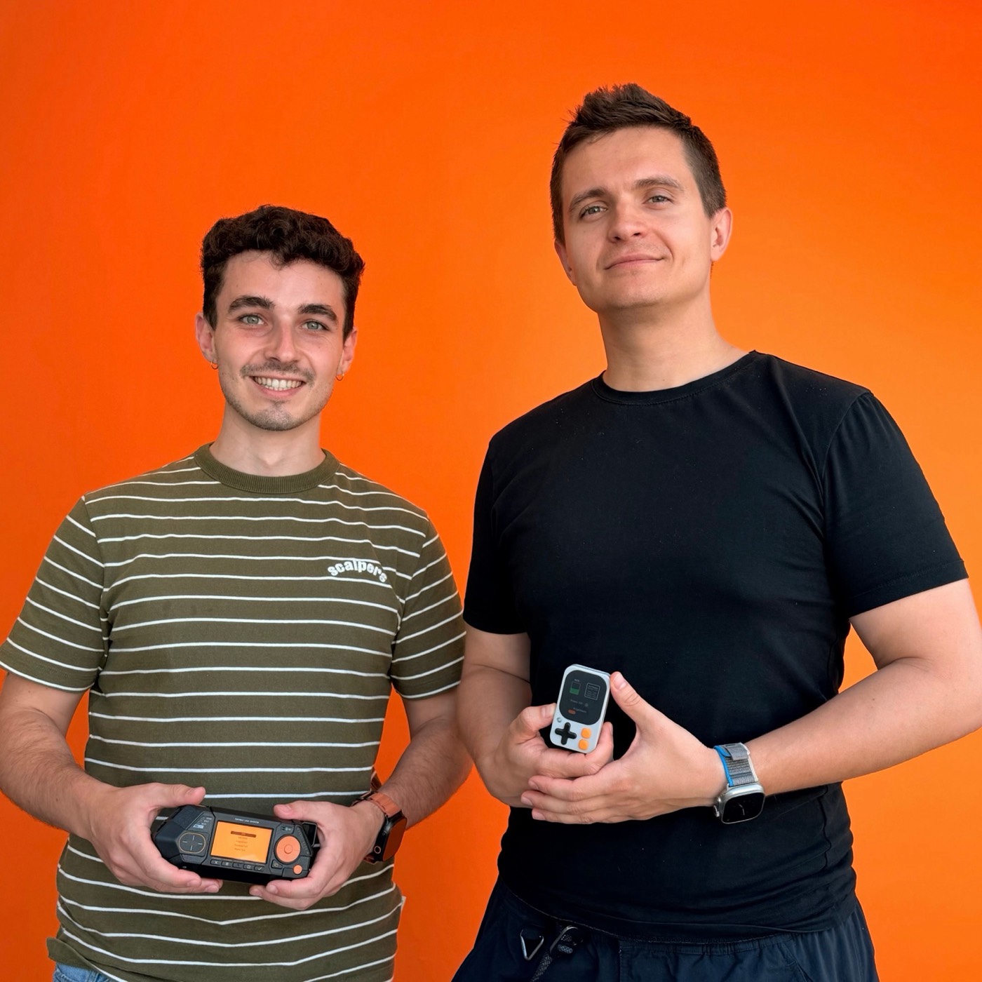 Kode co-founder with Pavlo Zhovner, CEO of Flipper Devices, each holding a device at the Flipper HQ in London