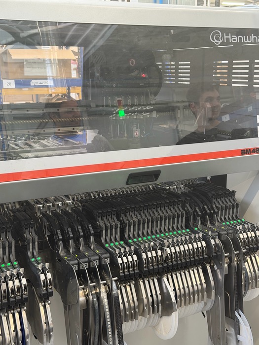 Pick-and-place machine loaded with component reels assembling the Kode Dot main PCB