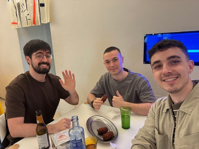 Three members of the Kode team sharing a meal around a table